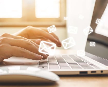 Hände die auf einer Laptop-Tastatur tippen