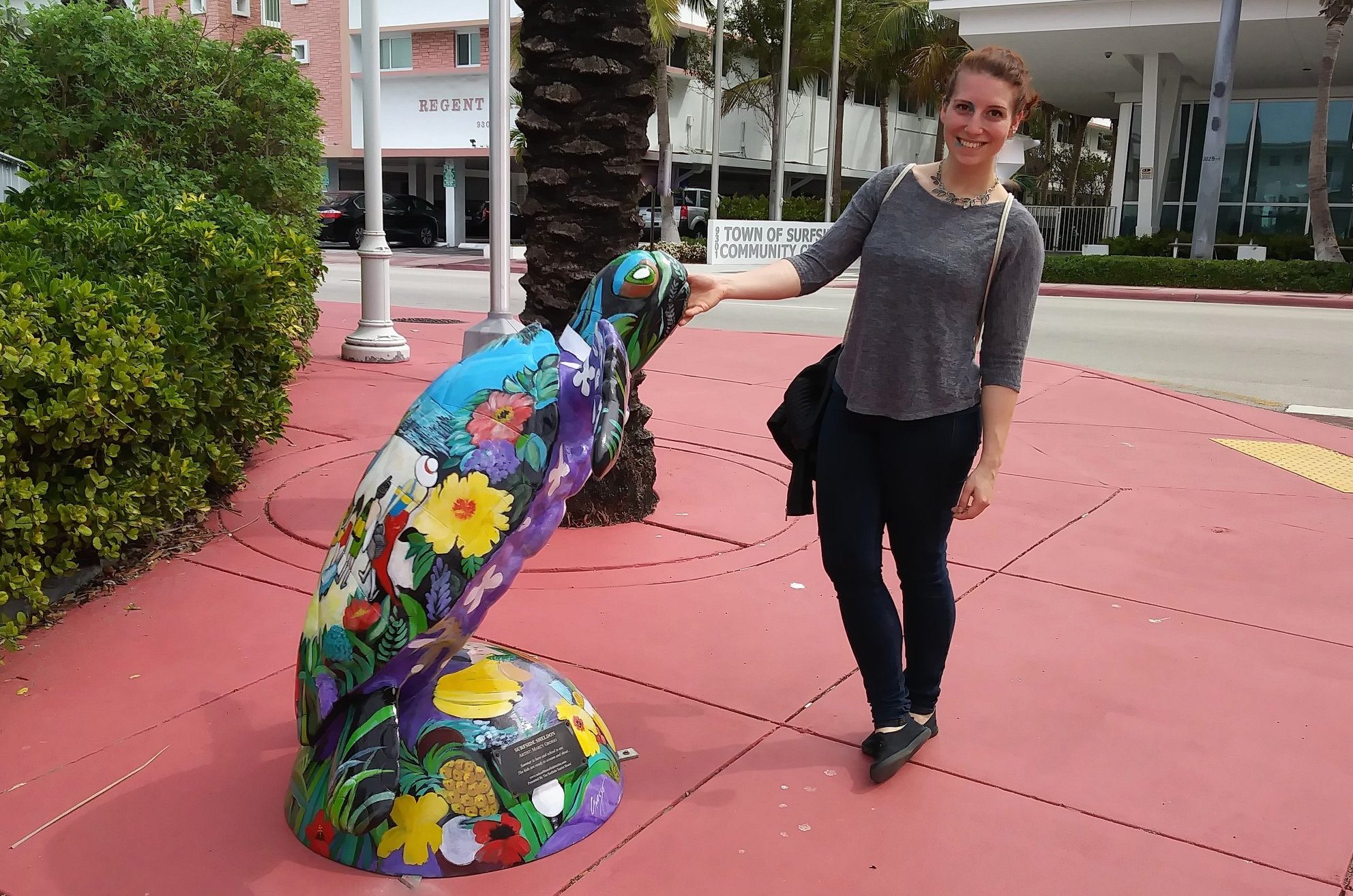 Travel Expert in Florida next to a turtle sculpture.